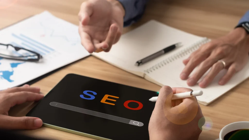 Hands analyzing SEO data on a tablet, aiming at finding your SEO baseline for optimized performance and ranking.